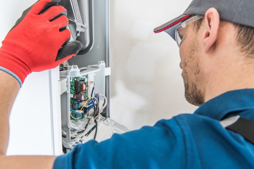 maintenance technician repairing a furnace